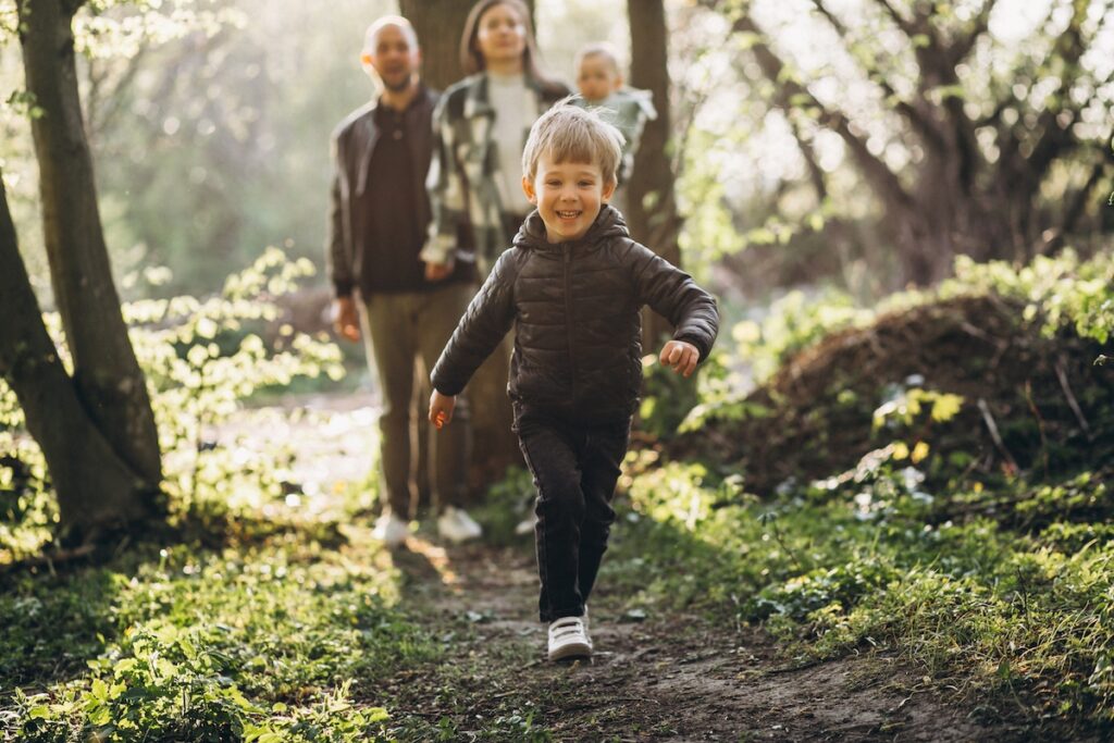 Young family with their kids having fun in the forest. B-complex